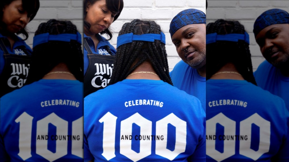 Three White Castle employees in new uniforms