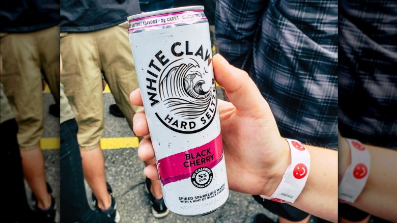 Person holding White Claw black cherry
