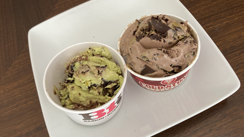 Scoops of Dubai chocolate ice cream in cups from Cold Stone and Baskin-Robbins on plate