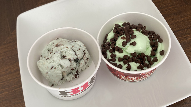 Scoops of mint chocolate chip ice cream in paper cups from Cold Stone and Baskin-Robbins