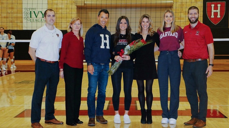 Isabelle Tashima with her father Paul, mother Jennifer, and sister Taylor, together with the coaching team of Harvard Women's Volleyball Team in 2019