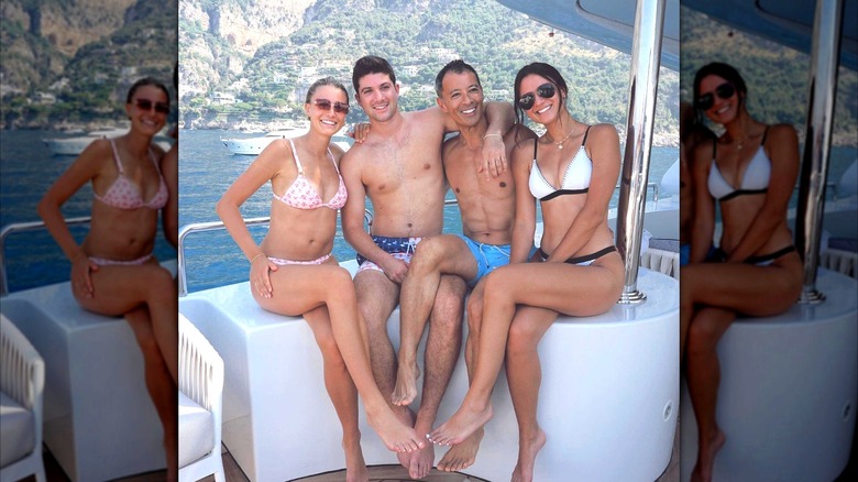 Isabelle Tashima posing on a yacht with her siblings, Taylor Tashima and Nick Tashima, and their dad, Paul Tashima