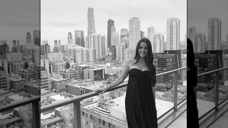 Isabelle Tashima poses on a balcony overlooking the Massachusetts city and skyline view