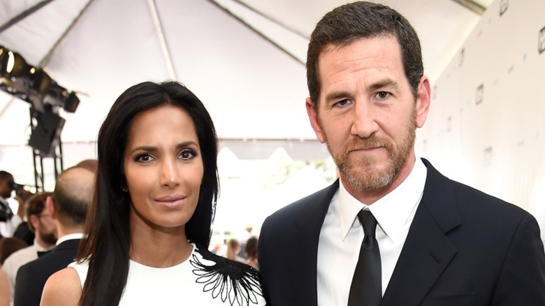 Padma Lakshmi and Adam Dell posing for the camera at a formal event.