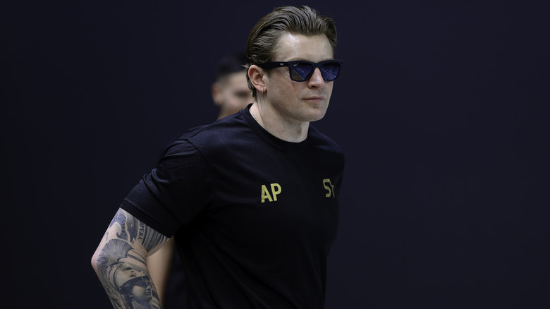 Adam Ramsay-Peaty in a dark colored shirt and sunglasses.