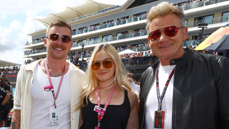 Adam and Holly Ramsay-Peaty with Holly's dad, Gordon Ramsay, at the 2023 Grand Prix of Great Britain.