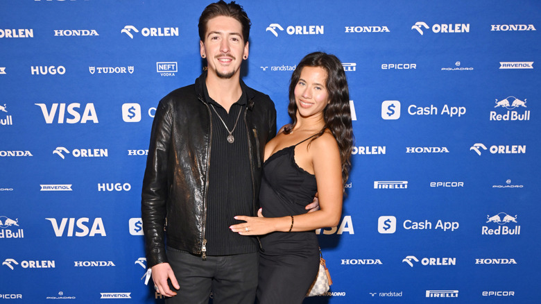 Hunter Fieri and Tara Bernstein wearing all black at Formula 1 race.