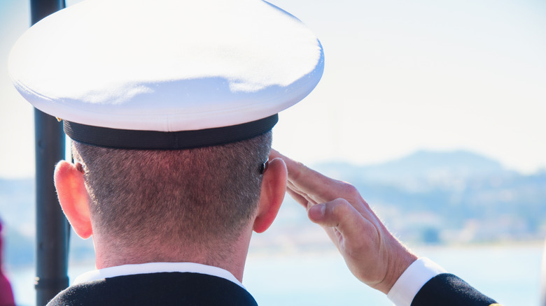 navy sailor saluting a ship