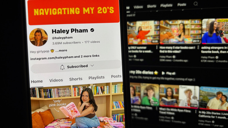 A phone in the foreground showing Haley's Youtube channel. Computer screen in the background showing the same thing