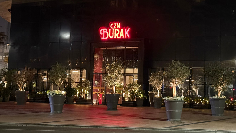 the facade of CZN Burak restaurant in Dubai at nighttime