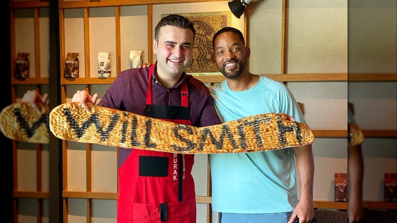 CZN Burak posing with actor Will Smith inside CZN Burak Restaurant in Dubai