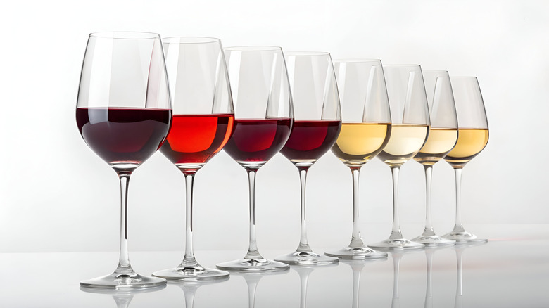 Various glasses of wine against white background