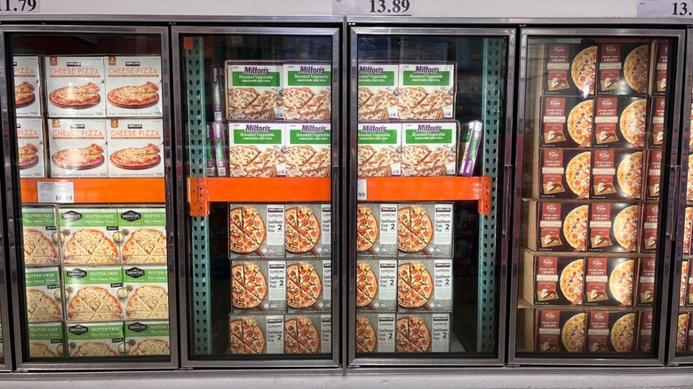 Costco freezer case with assorted brands of frozen pizza.