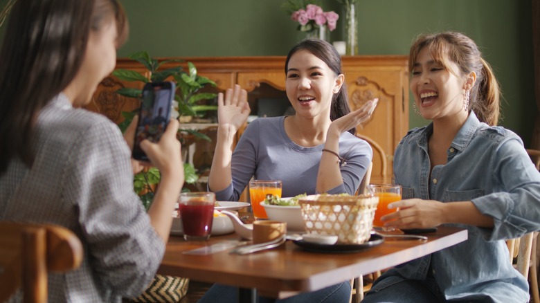 people filming restaurant experience 