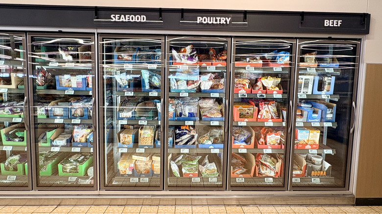 A frozen food aisle at an Aldi grocery store that includes seafood, poultry, and beef