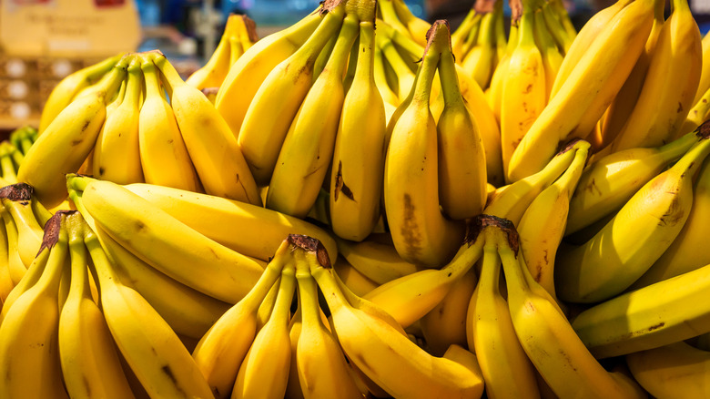 A pile of bunched yellow bananas