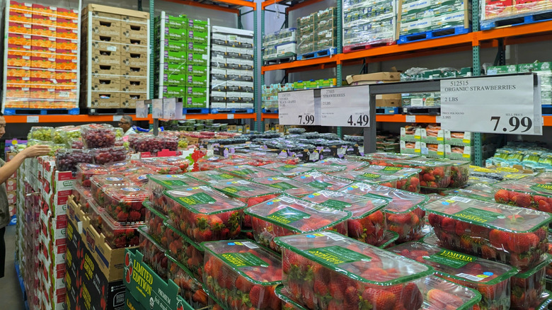 Packages of berries in Costco produce section.