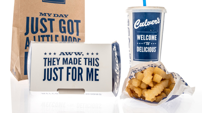 Culver's paper bag, cardboard box, bag of fries, and soda fountain drink