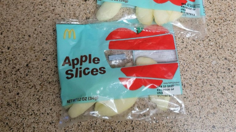 Two bags of McDonald's apple slices on counter