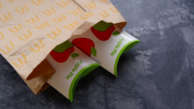 Top view of two McDonald's apple pies peeking from a brown paper bag