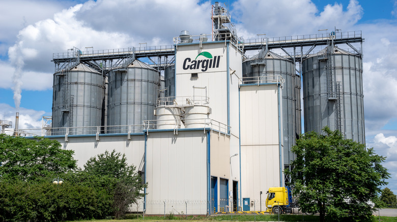 The exterior of a Cargill grain processing plant with a cloudy blue sky in the background