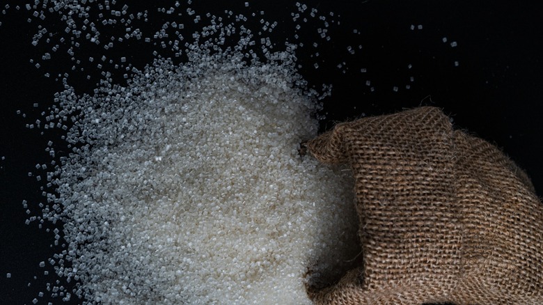 Sugar spilling from a burlap sack