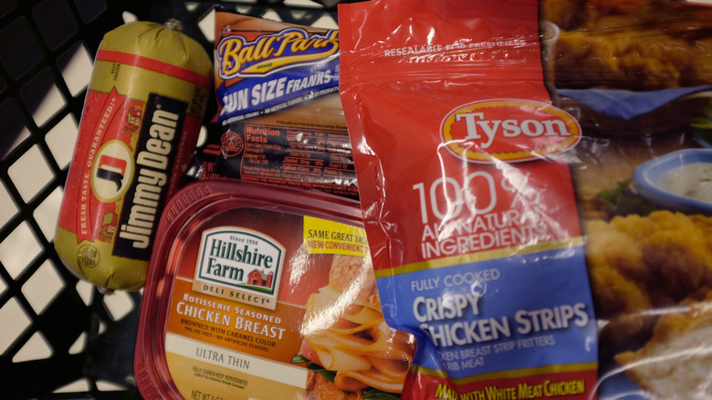 One Jimmy Dean sausage, a package of Tyson Crispy Chicken Strips, and Hillshire Farm Chicken Breast frozen meat products in a basket