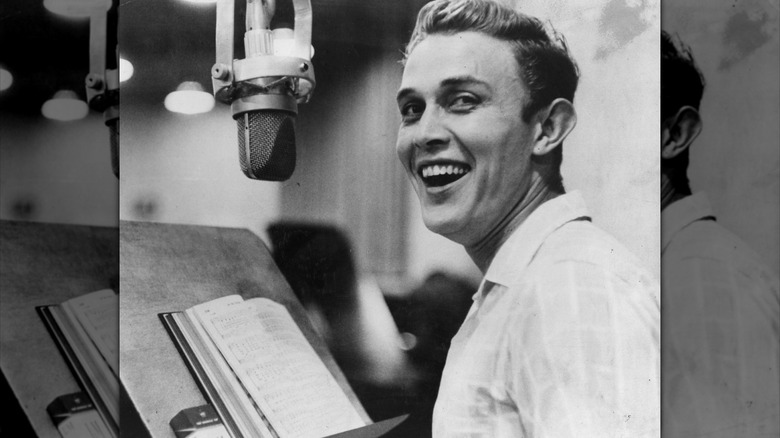 Black and white photo of Jimmy Dean in a recording booth