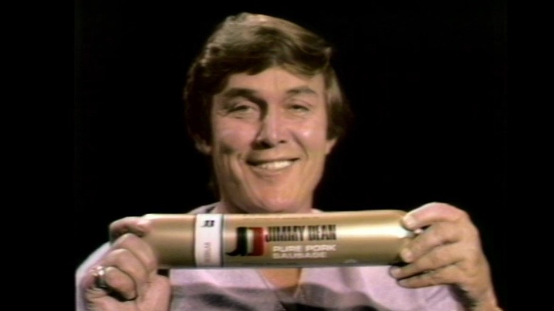 Jimmy Dean holding up a Jimmy Dean Pure Pork Sausage, a screenshot from a 1972 Mother's Day commercial