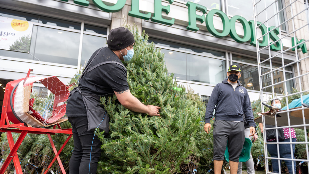 Whole Foods employee with Christmas tree