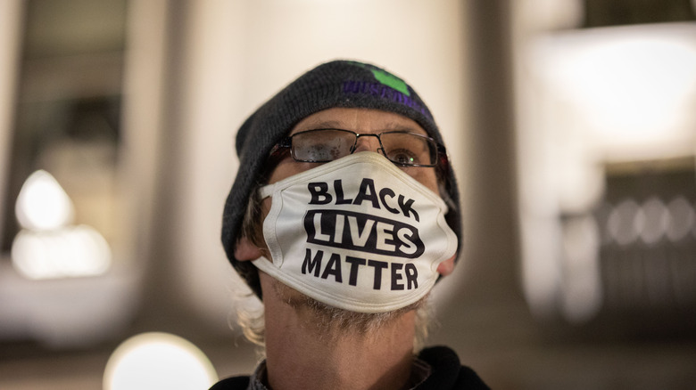 Person in a white Black Lives Matter mask