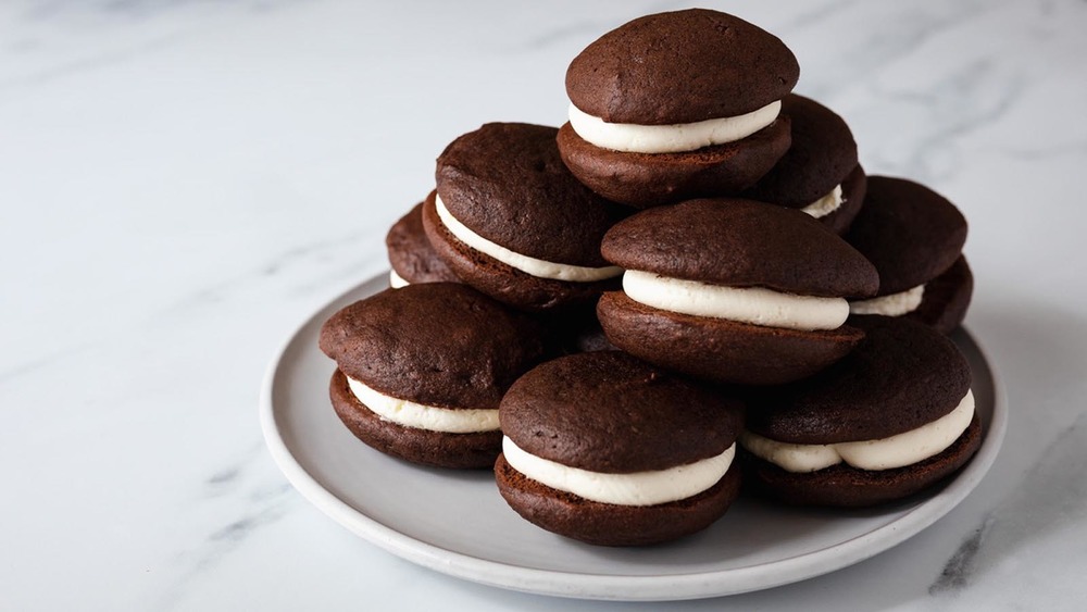 White plate of chocolate whoopie pies on a counter