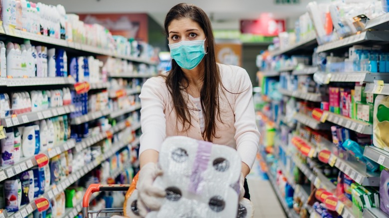 Masked woman buying toilet paper