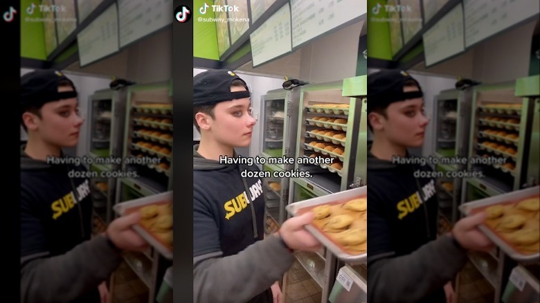 Subway employee making trays of cookies