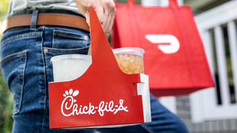 Man carries delivery food from Chick-fil-A