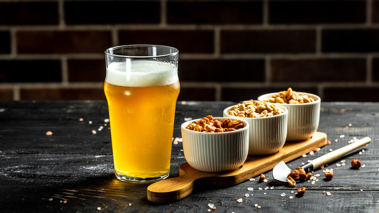 Beer with bowls of nuts