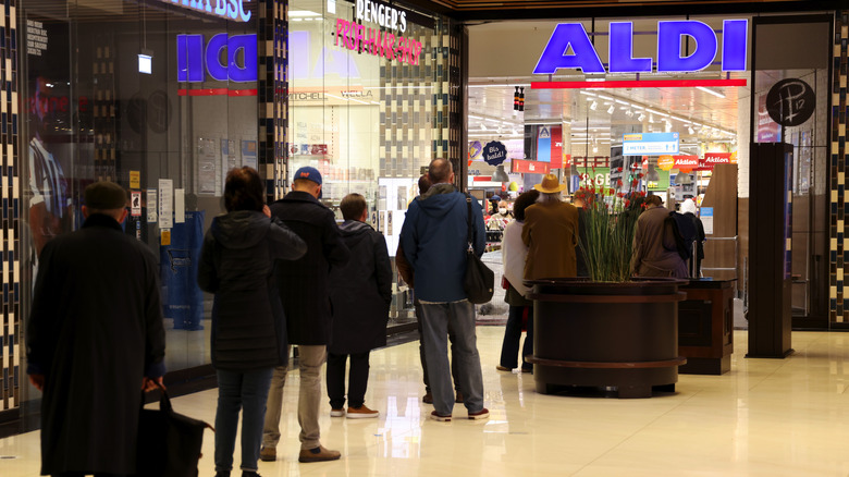 people lined up outside Aldi