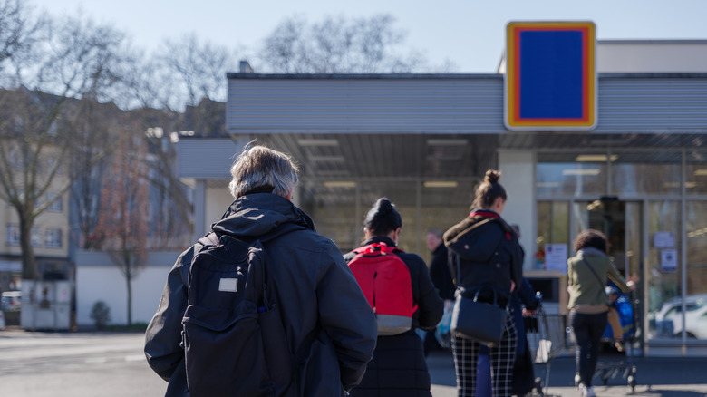 Aldi shoppers waiting in line outside the store