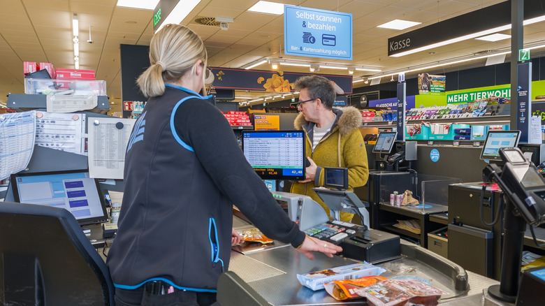 A customer checking out with an Aldi cashier