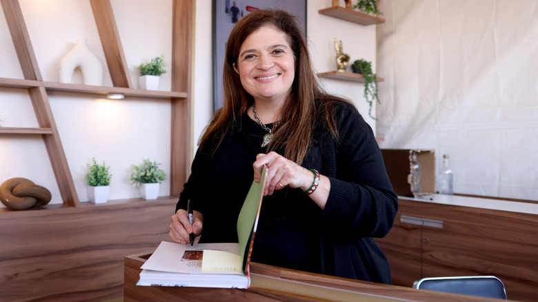 Alex Guarnaschelli signing book at the NYC Wine & Food Festival.