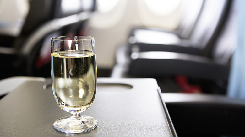 glass of wine in an airplane cabin