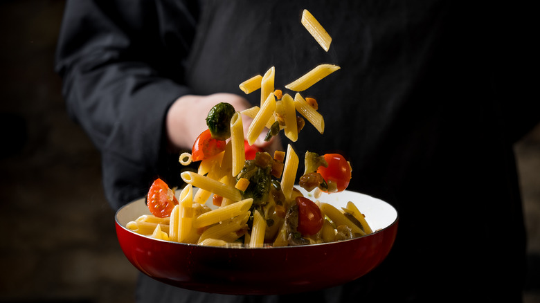 Chef tossing food from a pan