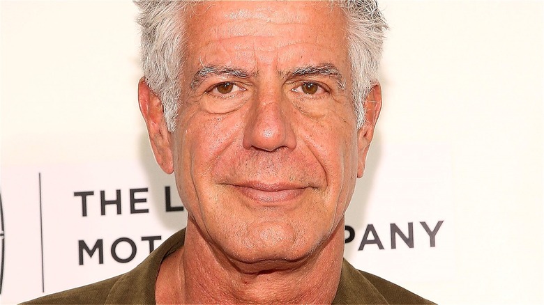 Anthony Bourdain half smiling 