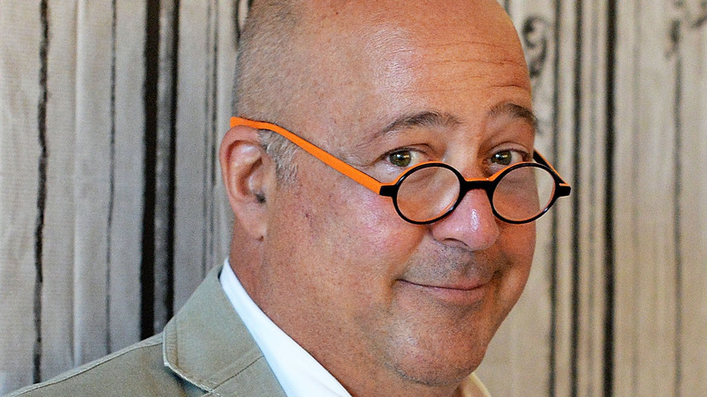 Andrew Zimmern in orange-framed glasses 