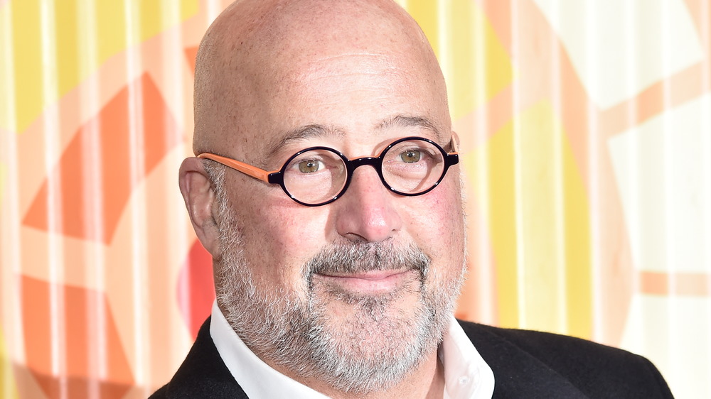 Andrew Zimmern in black and orange glasses