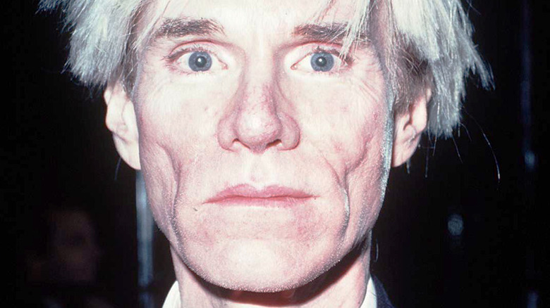 Andy Warhol staring into camera