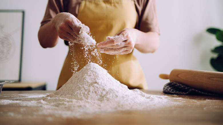 baker standing by pile of flour