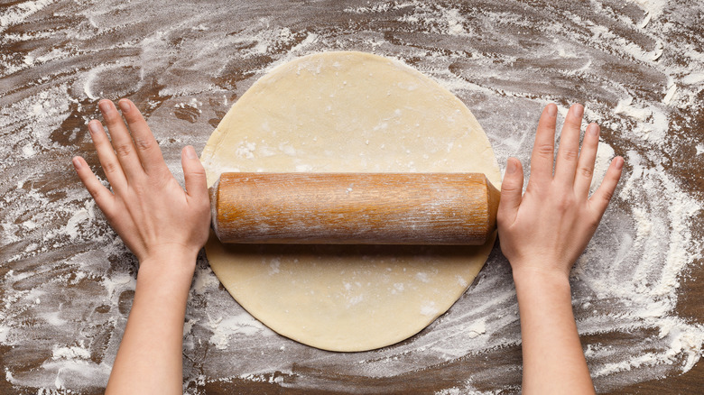 Hands rolling out pastry