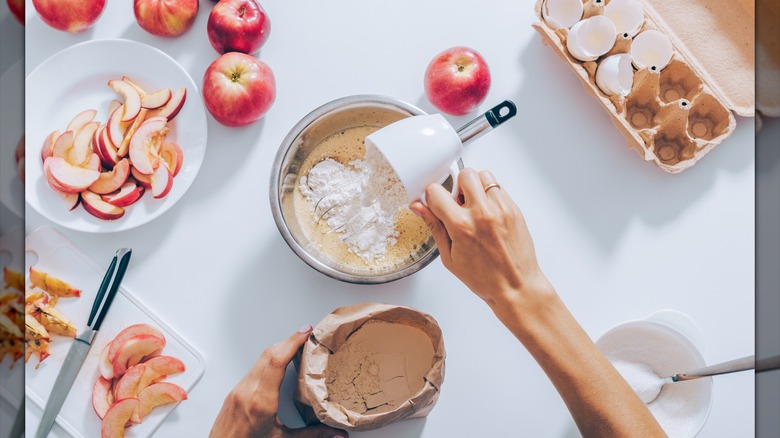 Person making apple pie dough