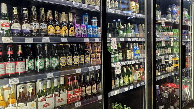 Various types of bottled beer in refrigerated case